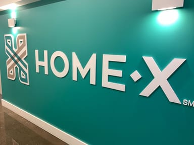 Homex logo on a green wall at the office