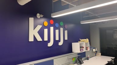 Kijiji logo printed on a purple wall at King Street Office